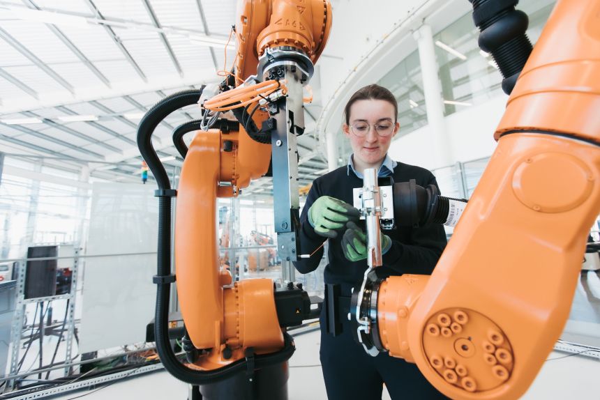 A Woman using machinery.